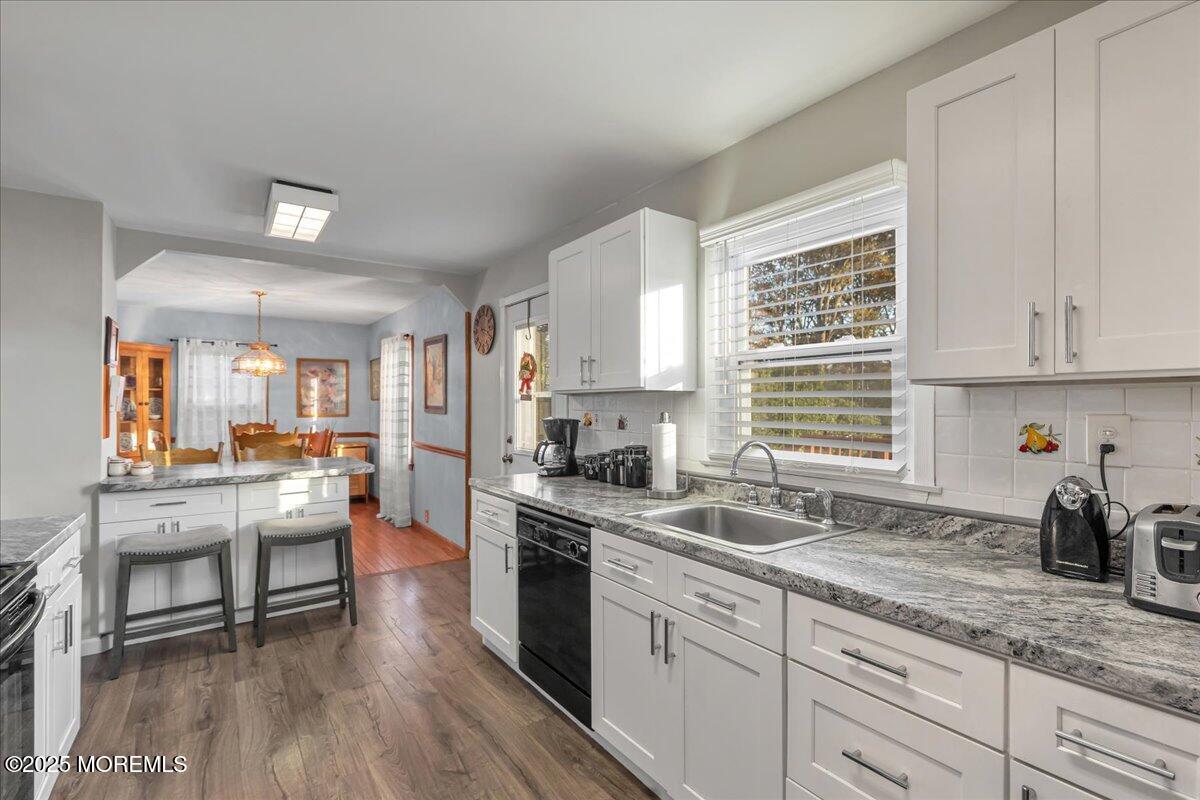 1211 18th Avenue West Belmar, NJ 07719 - Photo 11 of 40 a kitchen with granite countertop a sink cabinets stainless steel appliances and a window