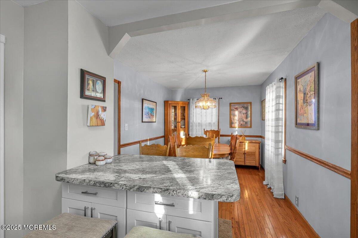1211 18th Avenue West Belmar, NJ 07719 - Photo 14 of 40 a view of a dining room with furniture a chandelier and wooden floor