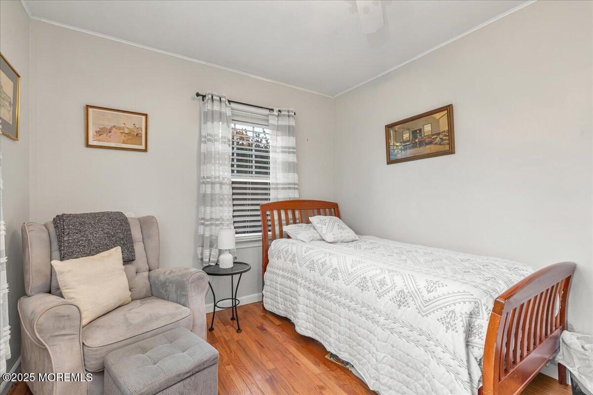 1211 18th Avenue West Belmar, NJ 07719 - Photo 19 of 40 a bedroom with a bed and wooden floor