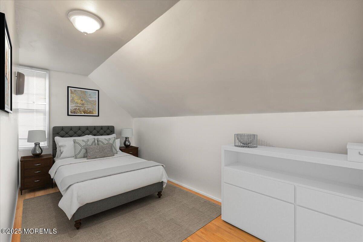 1211 18th Avenue West Belmar, NJ 07719 - Photo 20 of 40 a bed room with a bed and a night stand