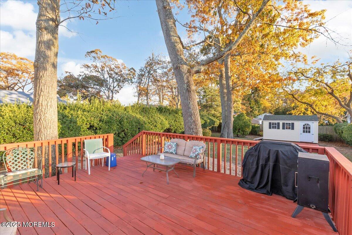1211 18th Avenue West Belmar, NJ 07719 - Photo 28 of 40 a view of a patio with table and chairs and wooden floor