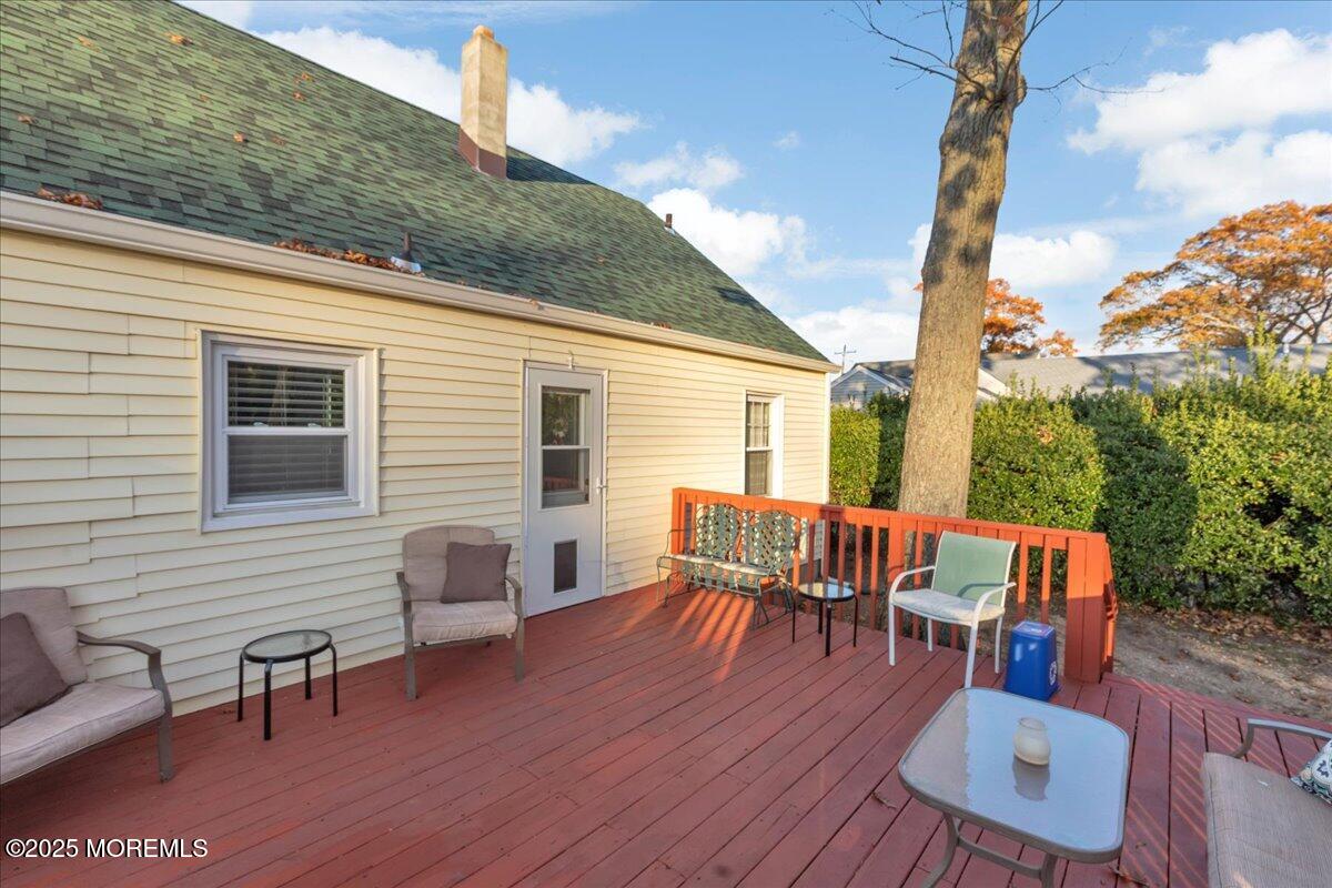 1211 18th Avenue West Belmar, NJ 07719 - Photo 29 of 40 a view of a patio with table and chairs and wooden floor