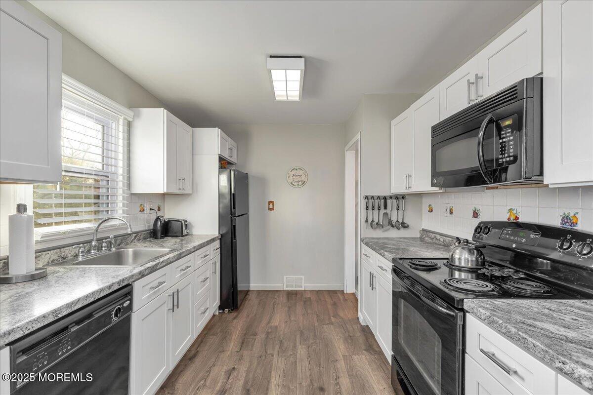 1211 18th Avenue West Belmar, NJ 07719 - Photo 9 of 40 a kitchen with stainless steel appliances granite countertop a sink stove and refrigerator