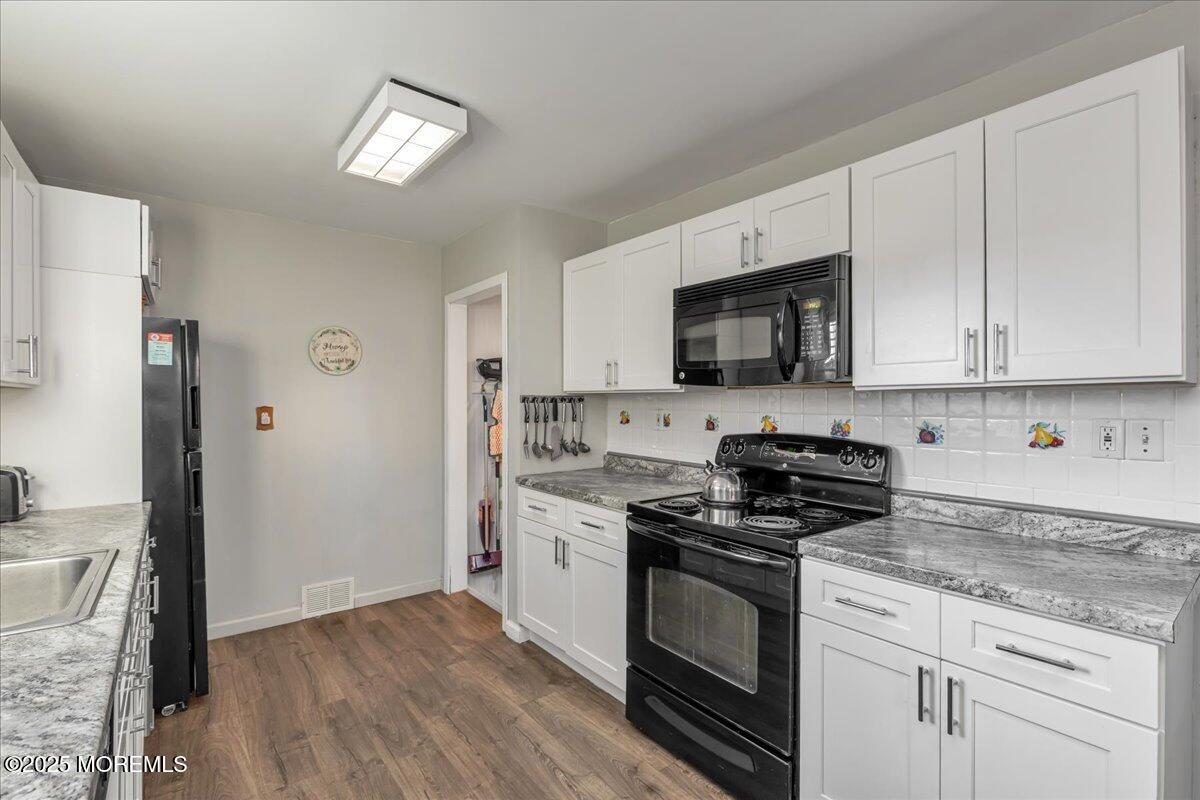 1211 18th Avenue West Belmar, NJ 07719 - Photo 10 of 40 a kitchen with stainless steel appliances granite countertop a stove a sink and a refrigerator