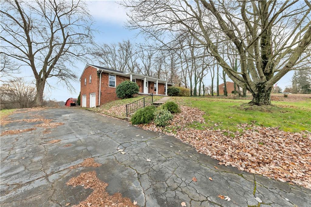 290 Bradys Ridge Road Beaver, PA 15009 - Photo 2 of 23 a view of a yard with a house and trees in the background