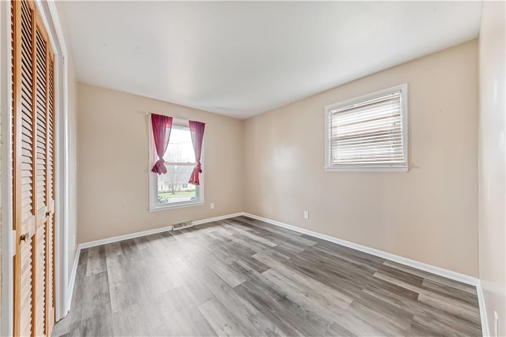 290 Bradys Ridge Road Beaver, PA 15009 - Photo 11 of 23 an empty room with wooden floor and windows