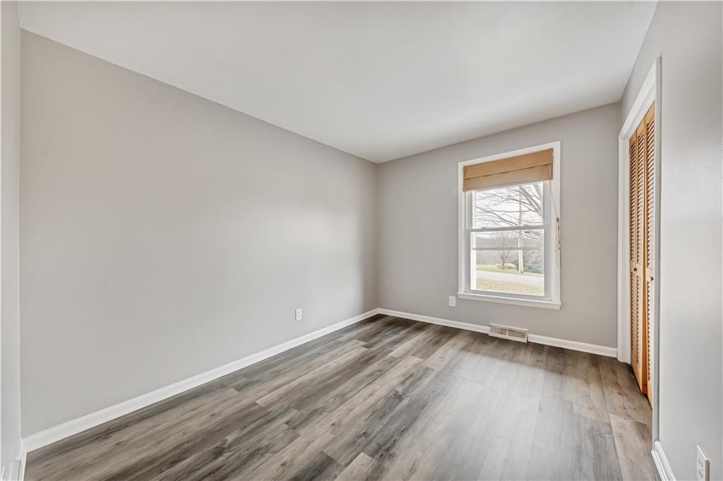 290 Bradys Ridge Road Beaver, PA 15009 - Photo 12 of 23 an empty room with wooden floor and windows