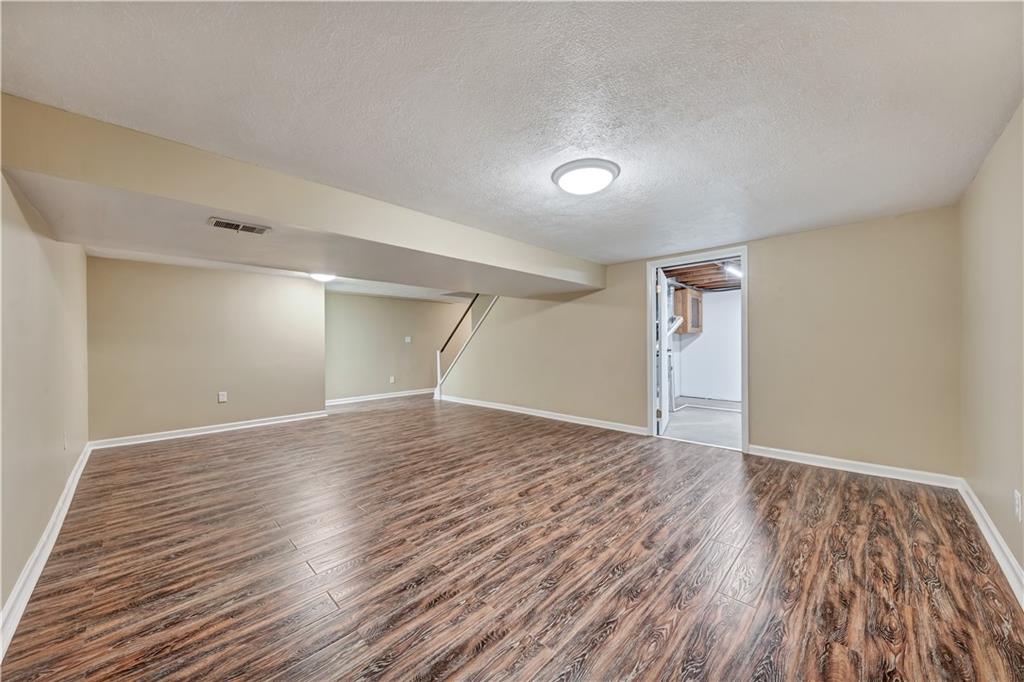 290 Bradys Ridge Road Beaver, PA 15009 - Photo 16 of 23 an empty room with wooden floor and windows