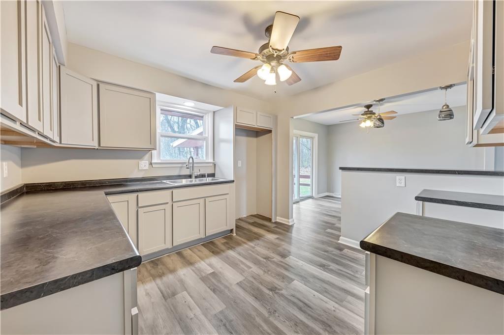 290 Bradys Ridge Road Beaver, PA 15009 - Photo 7 of 23 a kitchen with stainless steel appliances granite countertop a sink dishwasher and a stove with wooden floor