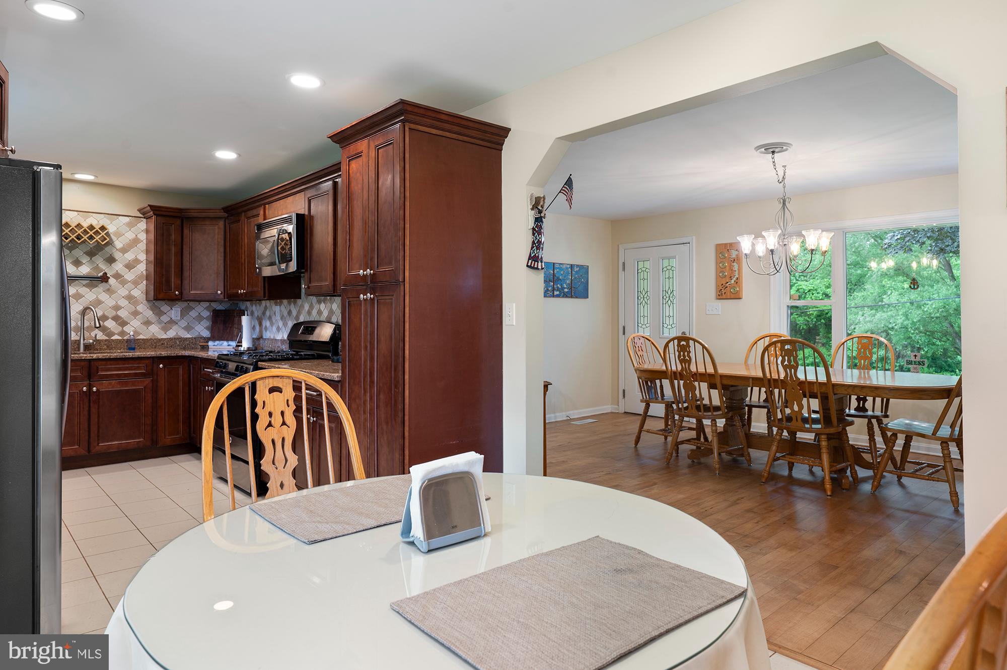 328 West Bay Front Road Lothian, MD 20711 - Photo 12 of 46 a kitchen with stainless steel appliances granite countertop a table chairs and a dining table