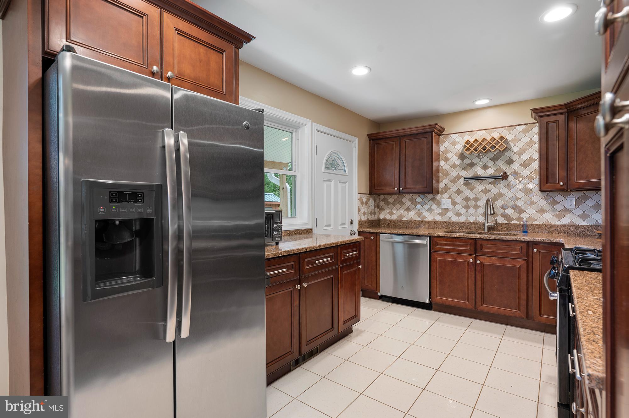 328 West Bay Front Road Lothian, MD 20711 - Photo 15 of 46 a kitchen with stainless steel appliances granite countertop a refrigerator and a sink