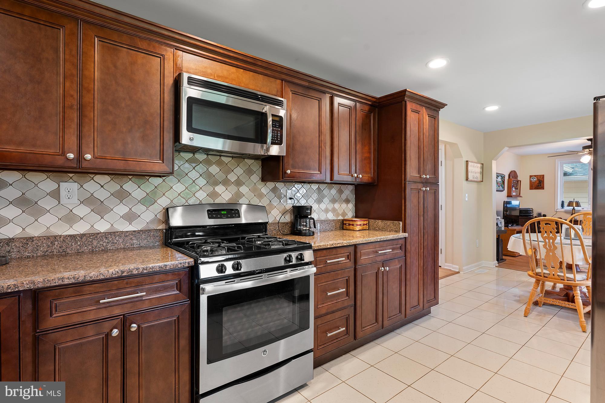 328 West Bay Front Road Lothian, MD 20711 - Photo 16 of 46 a kitchen with stainless steel appliances granite countertop a stove top oven a sink dishwasher and a microwave oven on the blue kitchen countertops