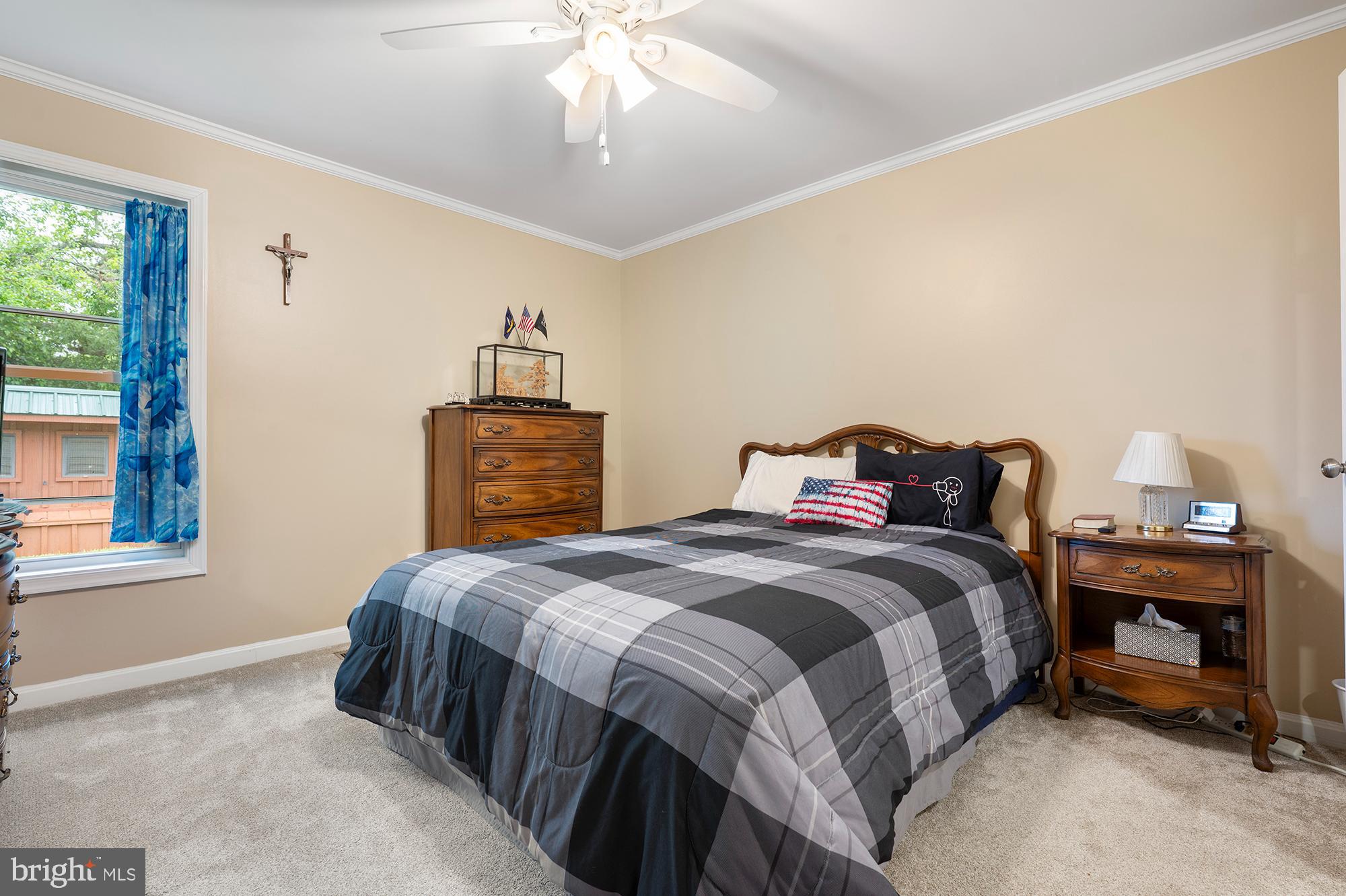 328 West Bay Front Road Lothian, MD 20711 - Photo 18 of 46 a bedroom with a bed and a chandelier