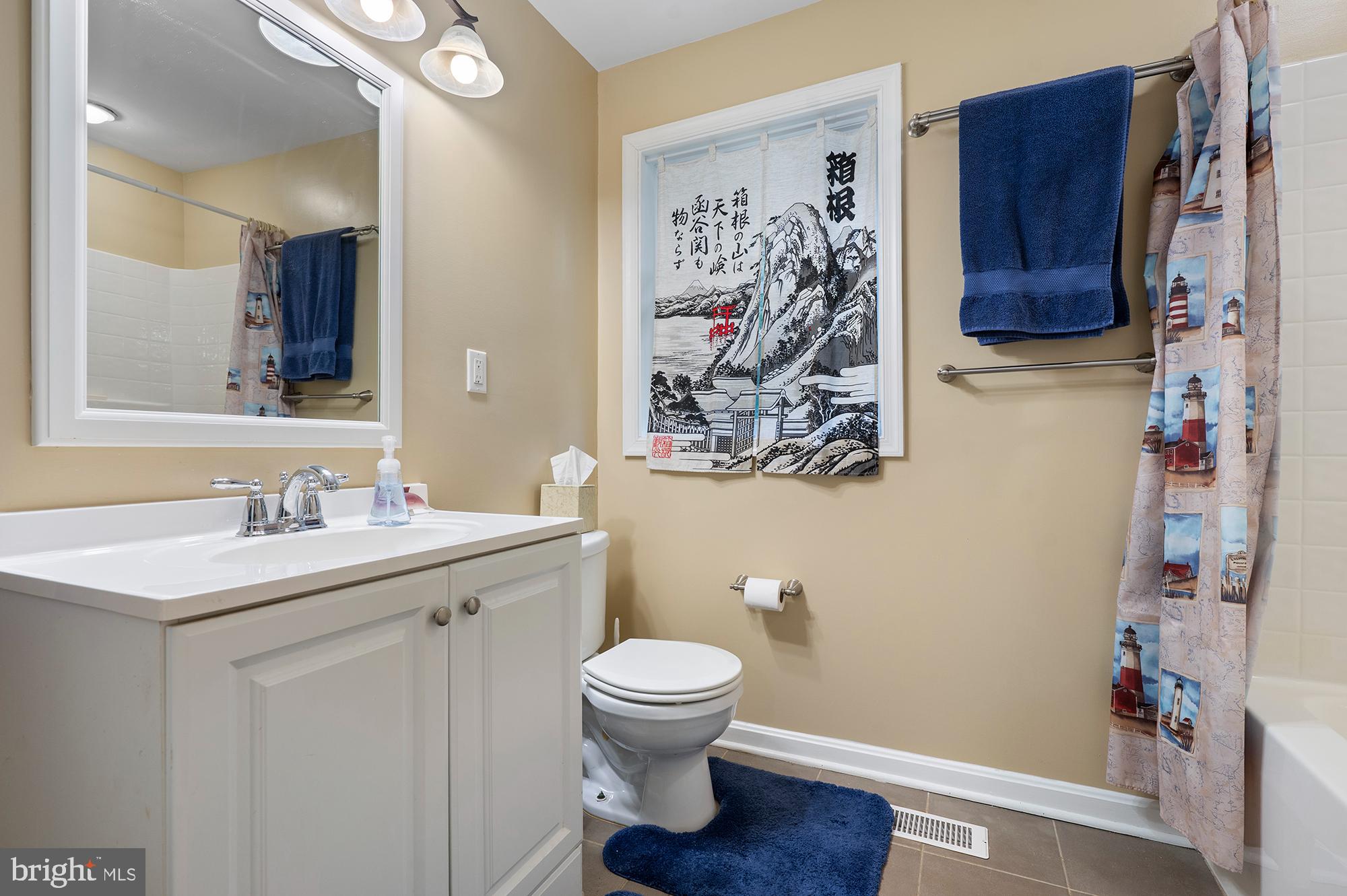 328 West Bay Front Road Lothian, MD 20711 - Photo 20 of 46 a bathroom with a toilet sink and mirror
