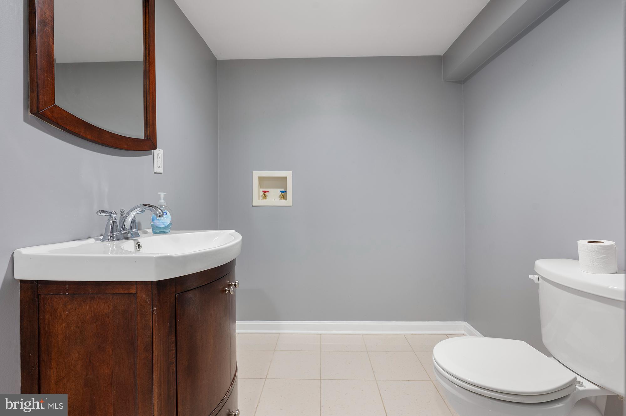 328 West Bay Front Road Lothian, MD 20711 - Photo 35 of 46 a bathroom with a sink a toilet and mirror