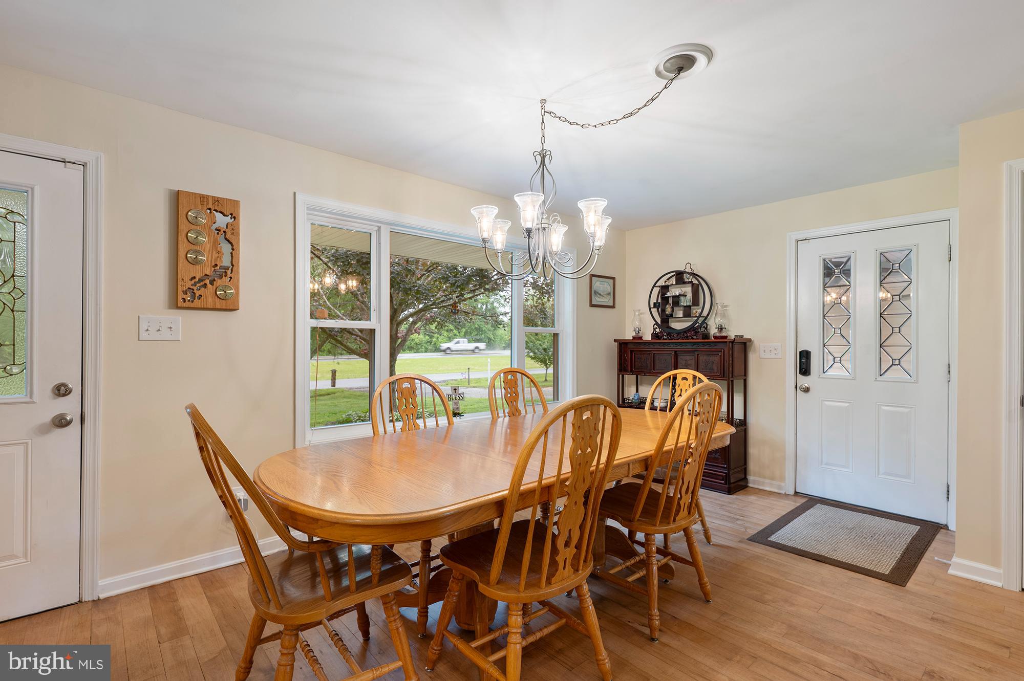 328 West Bay Front Road Lothian, MD 20711 - Photo 8 of 46 a dining room with furniture a chandelier and wooden floor