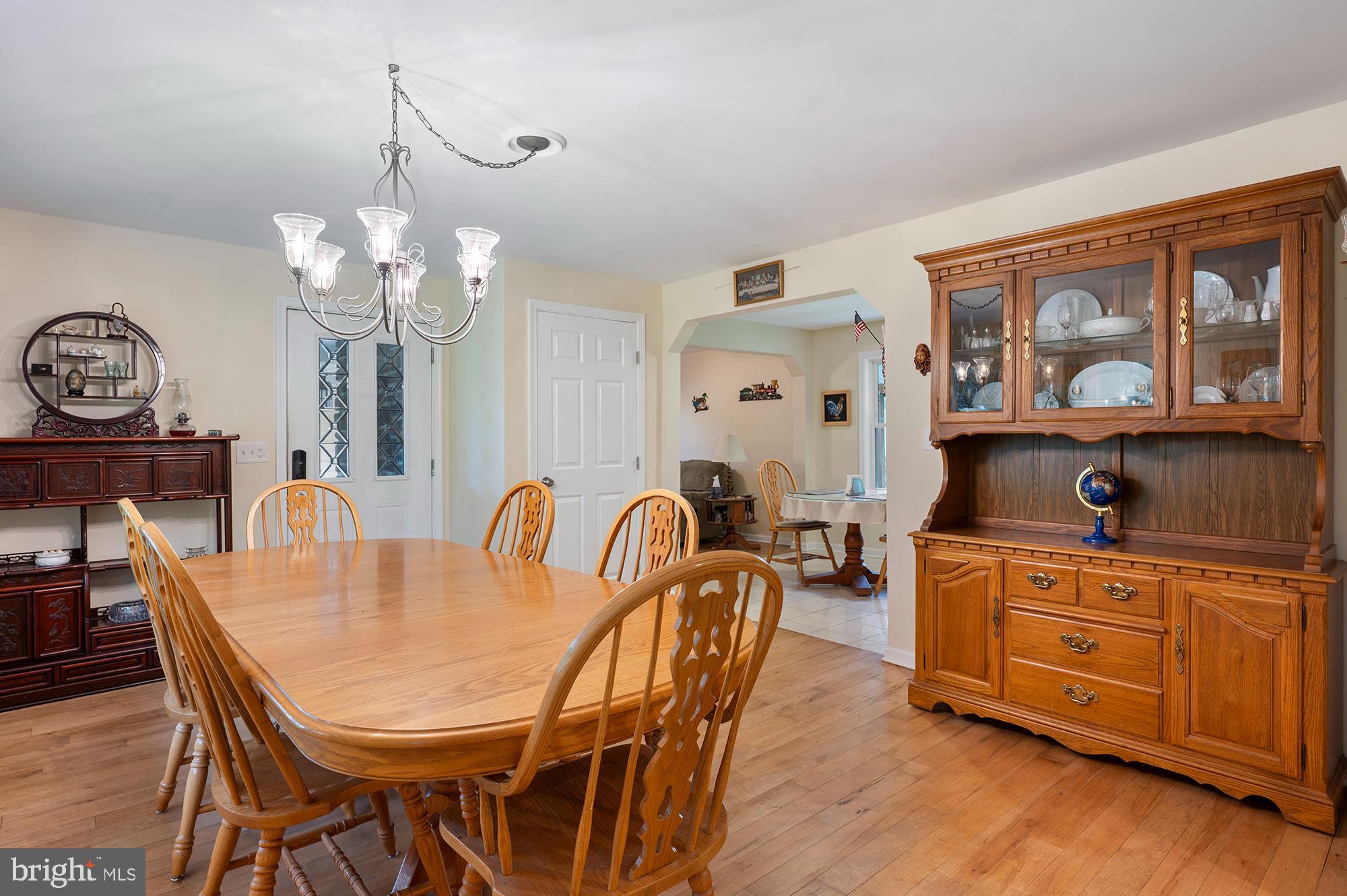 328 West Bay Front Road Lothian, MD 20711 - Photo 9 of 46 a dining room with furniture a chandelier and wooden floor