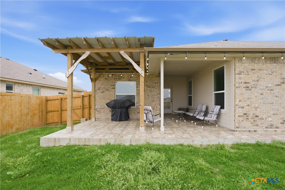 3201 Hedwig Street Killeen, TX 76549 - Photo 33 of 38 a view of a patio with table and chairs near a barbeque grill with plants and large trees