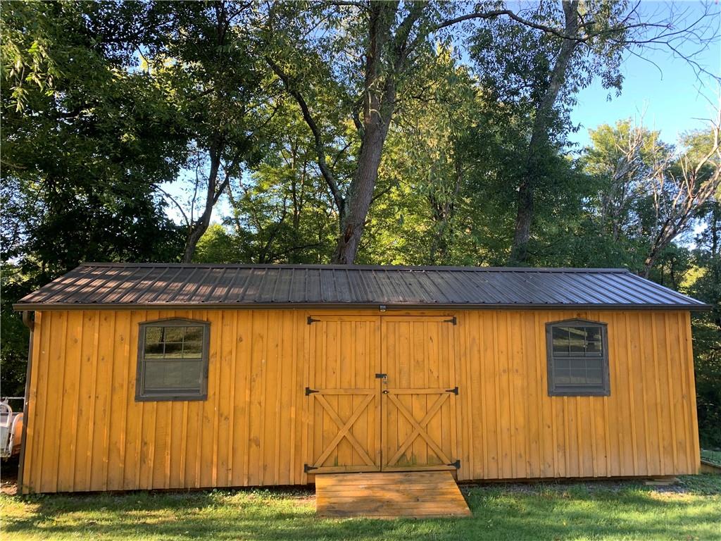 592 Herman Road Butler, PA 16002 - Photo 6 of 24 HUGE shed on property. Has garage door on right side for taking outdoor toys and tool in and out. Also has front doors and windows. This would be a great SHEshed.