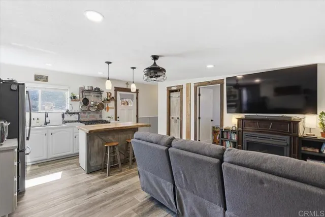 a view of a patio with table and chairs potted plants and floor to ceiling window