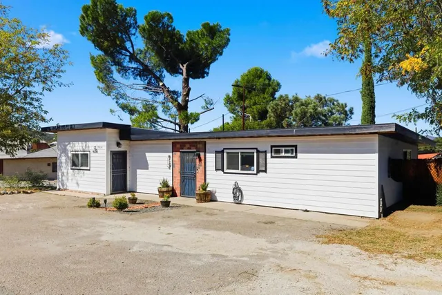 a view of a white house with a outdoor space