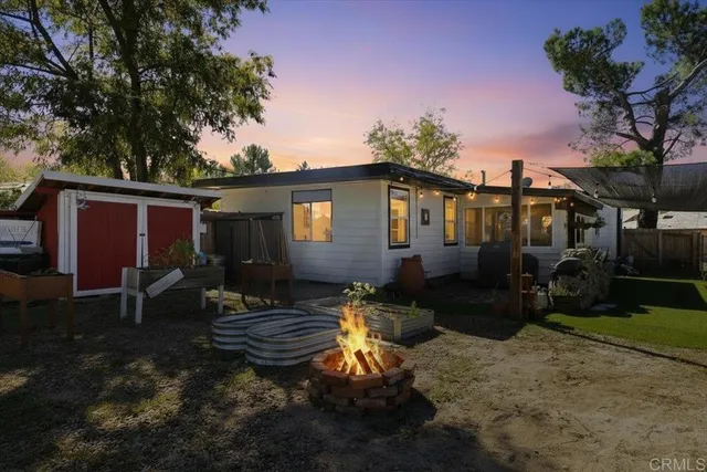 a backyard of a house with yard fire pit and outdoor seating