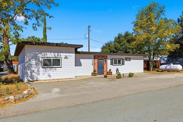 a large kitchen with stainless steel appliances kitchen island granite countertop a stove and white cabinets