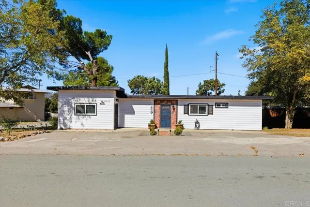 a kitchen with stainless steel appliances granite countertop a sink a stove and a wooden floors