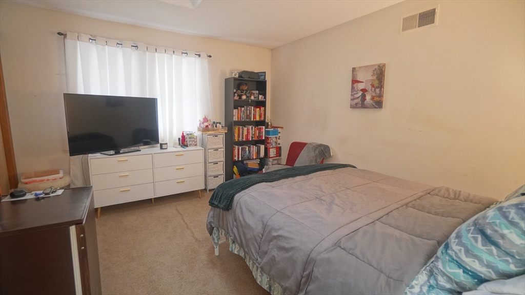 120 Lamplighter Lane, Unit C Springfield, MA 01119 - Photo 14 of 18 a bed room with a bed tv and a window