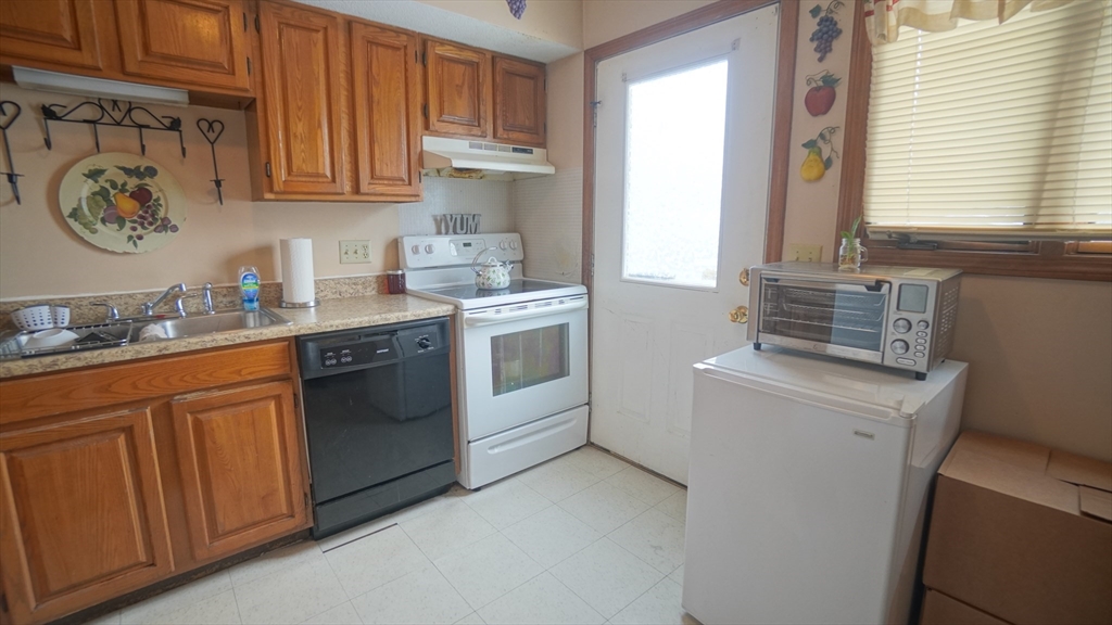 120 Lamplighter Lane, Unit C Springfield, MA 01119 - Photo 5 of 18 a kitchen with a stove top oven sink and cabinets