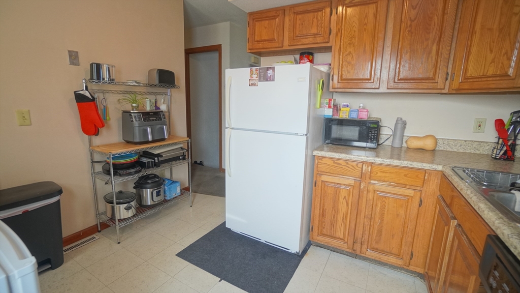 120 Lamplighter Lane, Unit C Springfield, MA 01119 - Photo 6 of 18 a white refrigerator freezer sitting in a kitchen