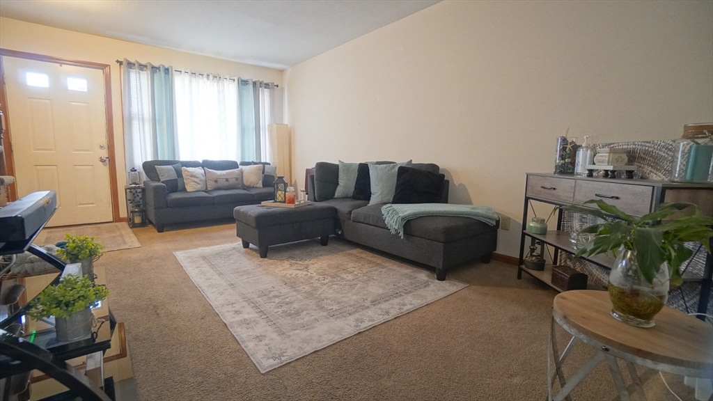 120 Lamplighter Lane, Unit C Springfield, MA 01119 - Photo 8 of 18 a living room with furniture and a large window