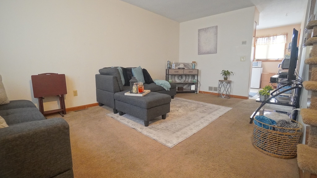 120 Lamplighter Lane, Unit C Springfield, MA 01119 - Photo 9 of 18 a living room with furniture and a flat screen tv