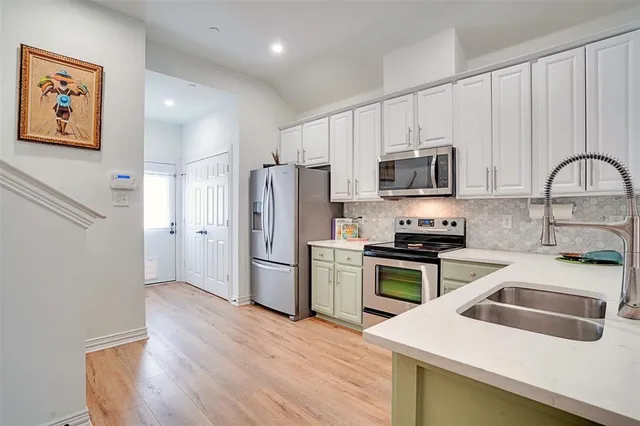 a kitchen with a refrigerator stove and sink