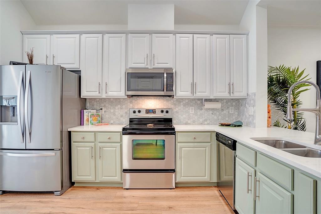 5713 Butterfly Way Fairview, TX 75069 - Photo 13 of 32 a kitchen with white cabinets white stainless steel appliances and refrigerator
