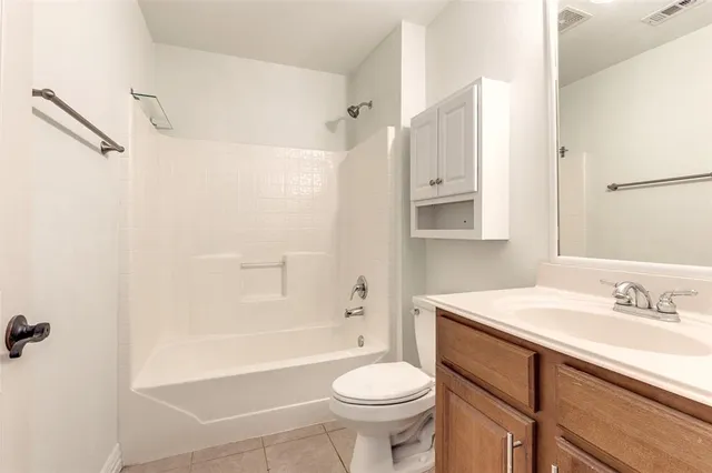 an empty room with wooden floor chandelier fan and windows