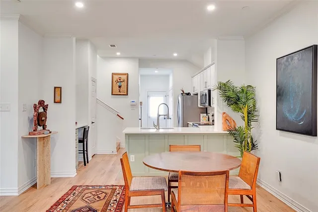 a view of a dining room with furniture and a potted plant