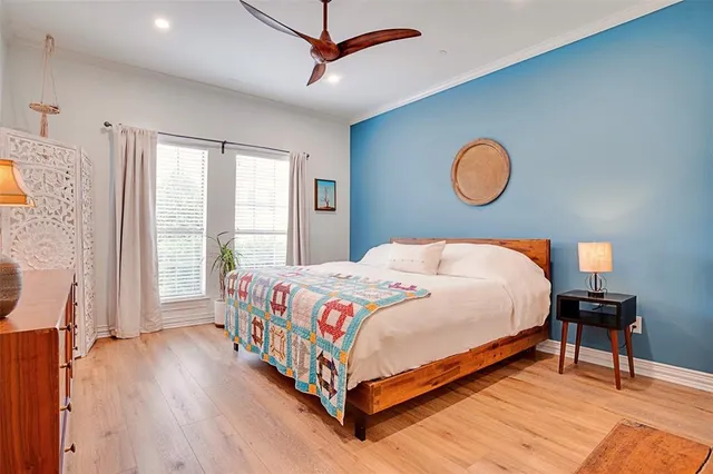 a bedroom with a bed and a large window