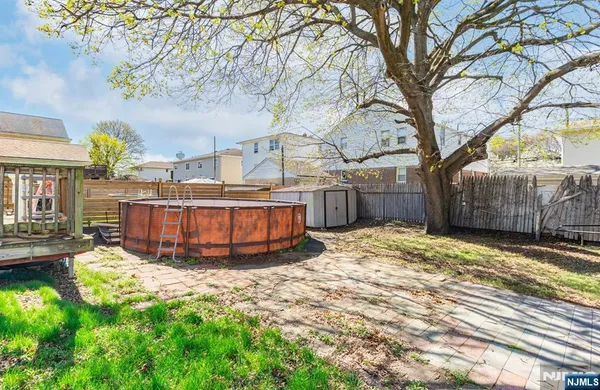 a view of a backyard with large trees