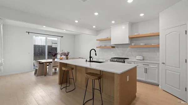 a kitchen with a sink stove and cabinets