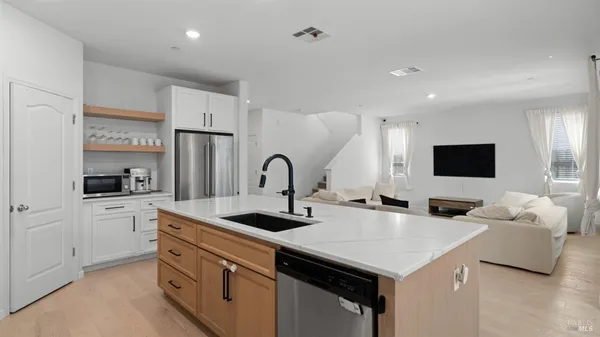a kitchen with stainless steel appliances and white cabinets