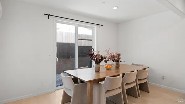 a dining room with furniture and window