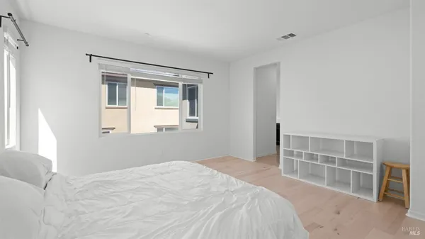a bedroom with a bed and a window