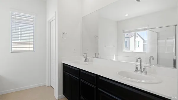 a bathroom with a sink double vanity and a mirror