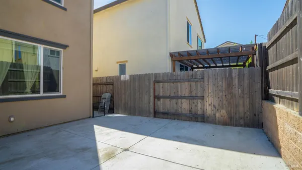 a view of a house with a wooden fence