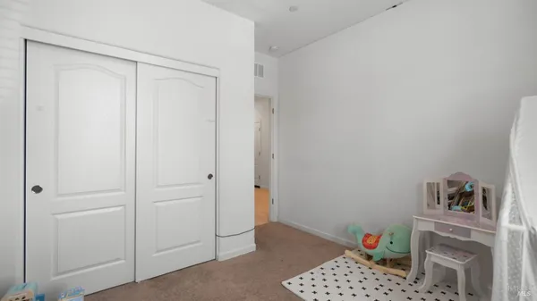 a view of room with baby crib and closet