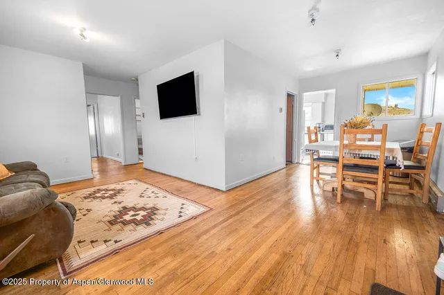 a view of a dining room with furniture and wooden floor