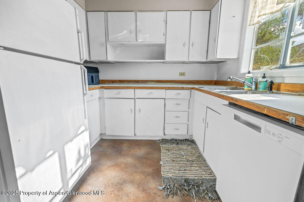 3362 County Road 7 Craig, CO 81625 - Photo 19 of 36 a kitchen with white cabinets and window