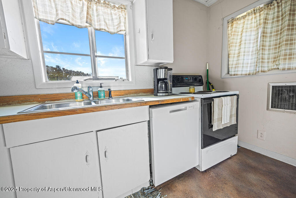 3362 County Road 7 Craig, CO 81625 - Photo 20 of 36 a kitchen with stainless steel appliances granite countertop a sink a stove and a window