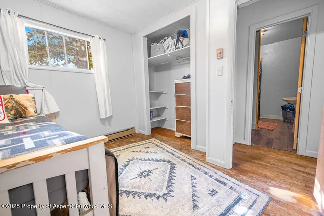 an empty room with windows and closet